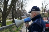 Raciborski policjant w rejonie parku przez urządzenie nagłaśniające przemawia do mieszkańców