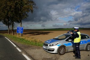 Policjant z drogówki z radarem mierzy prędkość