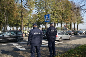 Widok policjantów na tle cmentarza