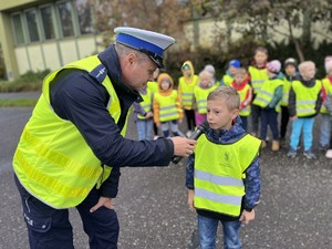 na zdjęciu policjant oraz uczeń co odpowiada na pytanie