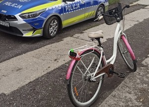na zdjęciu odzyskany rower, radiowóz w tle