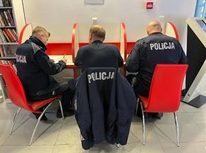 na zdjęciu policjanci wypełniają dokumentację niezbędną do poboru krwi