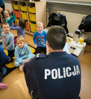 na zdjęciu policjant rozmawia z przedszkolakami