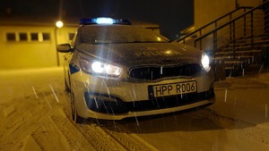 na zdjęciu radiowóz i padający śnieg