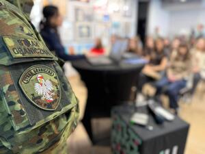 na zdjęciu policjantka prowadzi konferencję