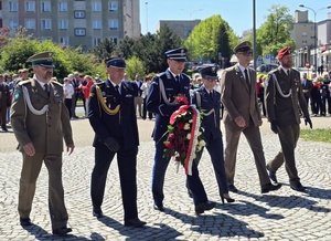 na zdjęciu przedstawiciele służb mundurowych, składający kwiaty pod pomnikiem Matki Polki